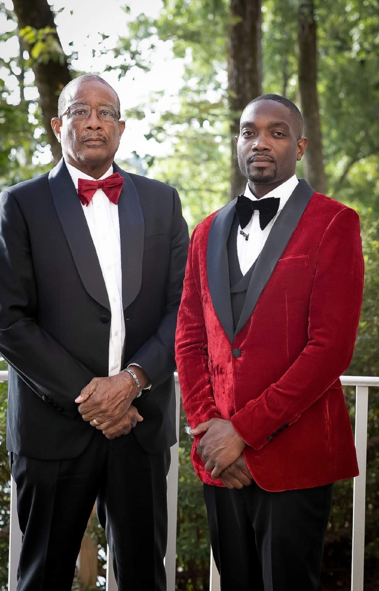 Two gentlemen in classic black and red velvet tuxedos